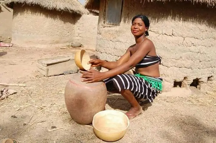 This girl is working with a traditional pot